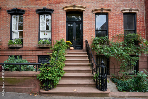 Фотография a view of a row of historic brownstones in an iconic neighborhood of Manhattan,