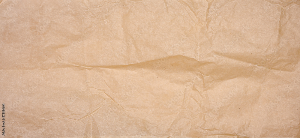 Fototapeta premium Crumpled brown parchment paper, close up