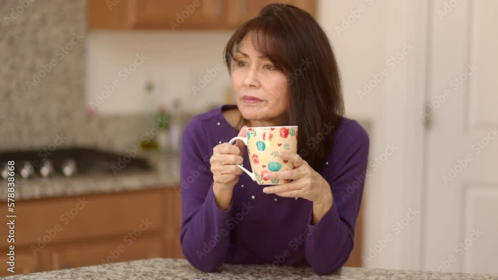 Attractive stylish woman enjoying drinking morning coffee for breakfast holding hot cup looking around relaxing standing at home kitchen island. Beautiful mature female happy with beverage. Attractive stylish woman enjoying drinking morning coffee for breakfast holding hot cup looking around relaxing standing at home kitchen island. Beautiful mature female happy with beverage.
