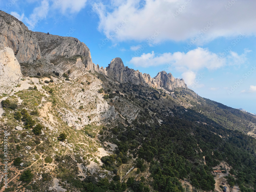 Aerial Panoramic view on Sierra de Bernia rocky mountain ridge in clouds. Natural park touristic attraction on  Costa Blanca, Alicante province, Spain. 