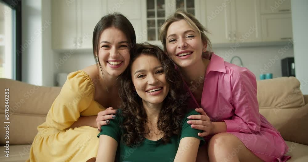 A Group of friends woman portrait sit on sofa and floor A Group of friends woman portrait sit on sofa and floor