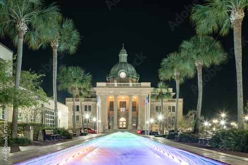 Evening photo of the historic Volusia County Courthouse and fountain pool in DeLand, Florida. photo