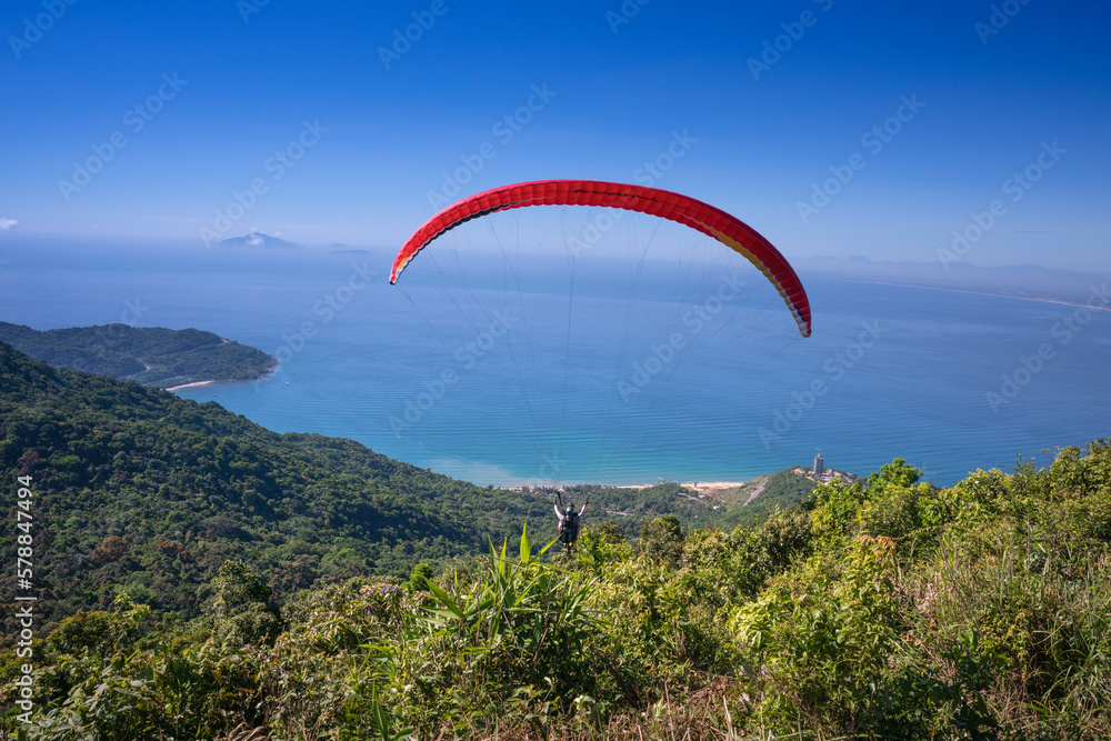 Da Nang city, Quang Nam province, Vietnam - June 25, 2017: flying paragliding on top of Son Tra Mountain. This is a regular activity of parachute flying club Da Nang city, Quang Nam province, Vietnam - June 25, 2017: flying paragliding on top of Son Tra Mountain. This is a regular activity of parachute flying club