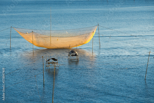 Fishing at Cua Dai on the Thu Bon River. Fishermen working on the Thu Bon River in Cua Dai fishing village, Hoi An, Quang Nam, Vietnam
 
 