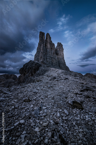 Torri del Vajolet mountain range in Trentino, Italy at sunset over a cloudy sky photo