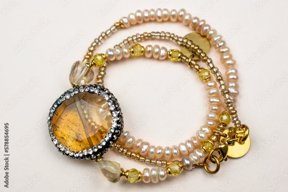 Obraz premium Colorful gemstone crystal beads necklace on white, unique handmade jewelry background
