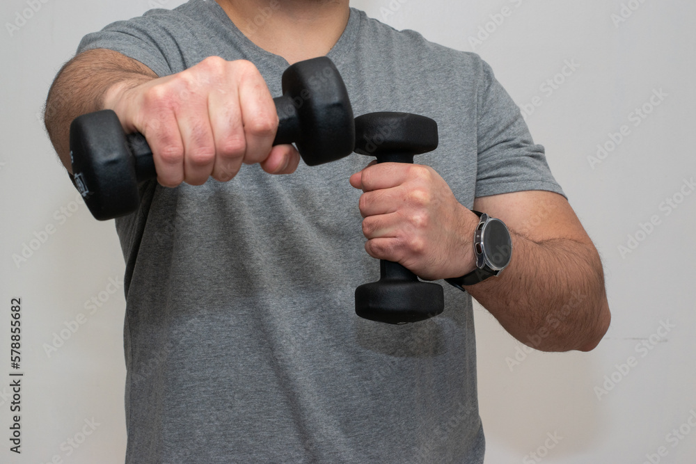 Man pushing their hand with dumbbells and weight Man pushing their hand with dumbbells and weight