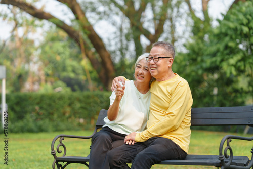 Never stop loving each other, Asian people elderly husband and wife relaxing in park outdoor in springtime. © NanSan
