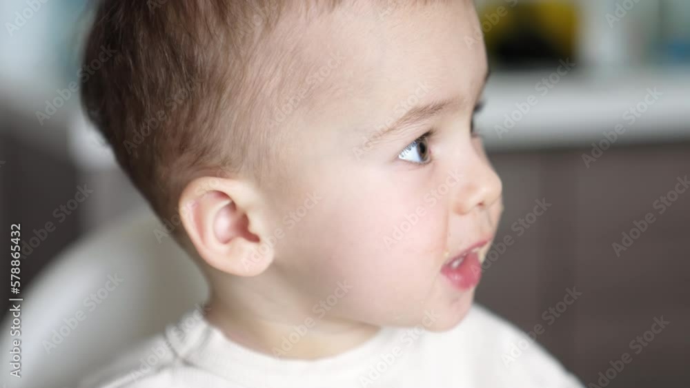 Face of a lovely Caucasian baby during meals. Nice little boy with food around mouth. Close up portrait. Face of a lovely Caucasian baby during meals. Nice little boy with food around mouth. Close up portrait.