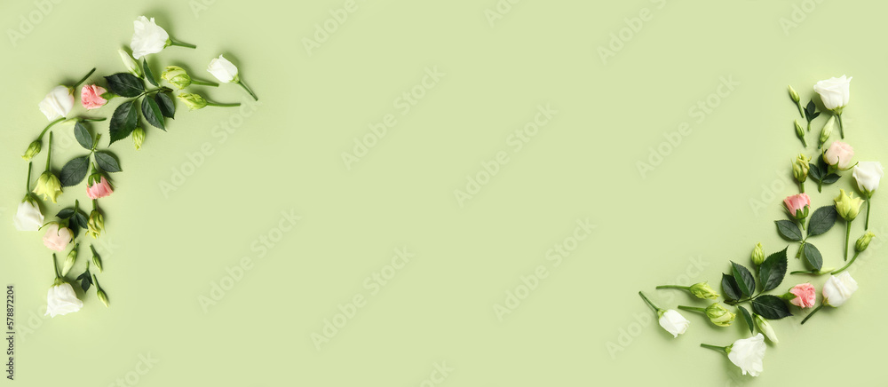 Naklejka premium Composition with eustoma and rose flowers on green background with space for text