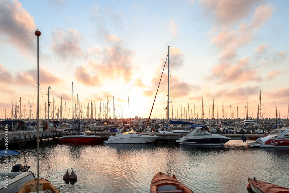 View of beautiful pier with yachts at sunset View of beautiful pier with yachts at sunset