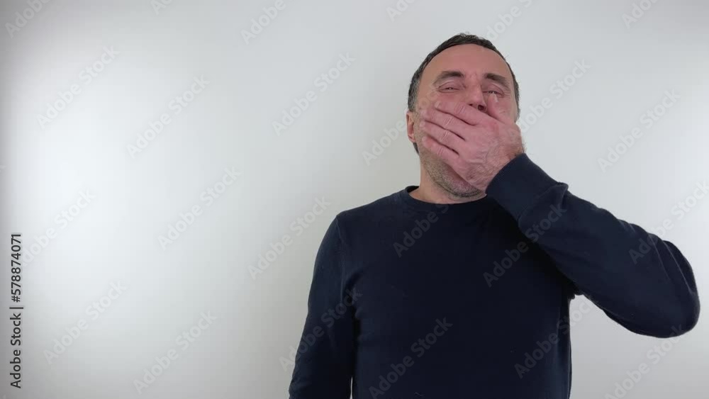 Emotions of a man man yawns he closed his eyes tightly and opened his mouth Hairy hands lie on his cheeks Emotions of a man man yawns he closed his eyes tightly and opened his mouth Hairy hands lie on his cheeks