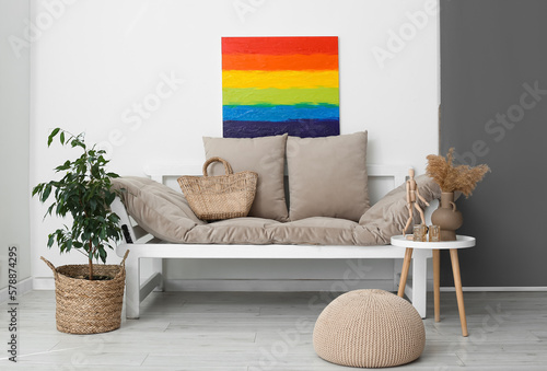 Fototapeta Naklejka Na Ścianę i Meble -  Interior of light living room with rainbow painting and couch