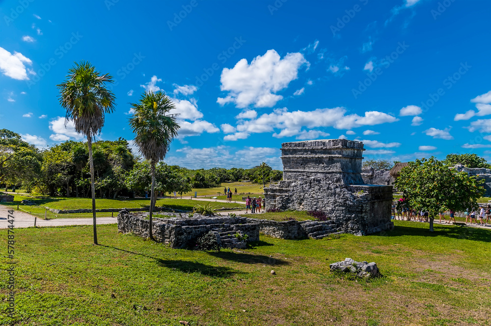 A view towards the palace ruins at the Mayan settlement of Tulum, Mexico on a sunny day