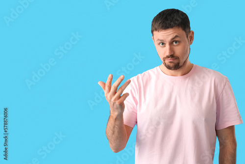 Handsome man in t-shirt on blue background