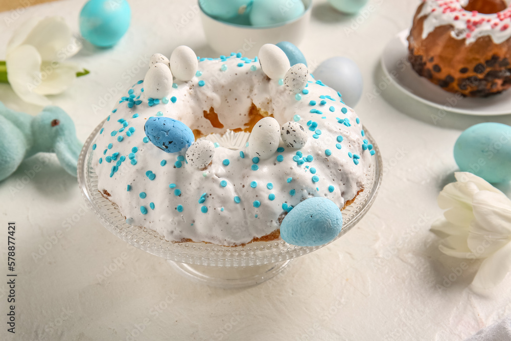 Dessert stand with tasty Easter cake on light background Dessert stand with tasty Easter cake on light background