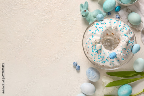 Composition with tasty Easter cake, eggs and tulip flower on light background #578877423