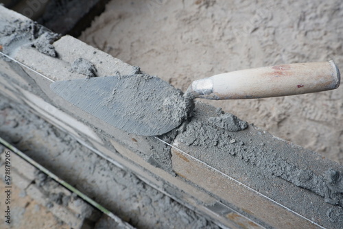 selectively focus on the dirty cement spoon because it is used to install bricks, in Indonesian the cement spoon is called cetok, soft focus
