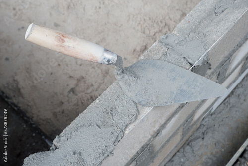 selectively focus on the dirty cement spoon because it is used to install bricks, in Indonesian the cement spoon is called cetok, soft focus