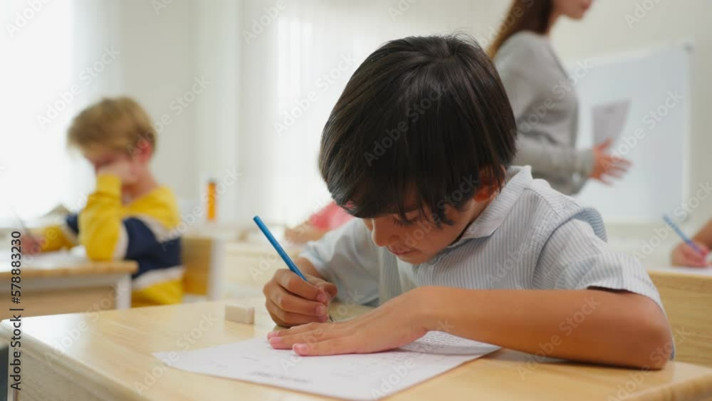 Adorable student learn with teacher in classroom at elementary school. Adorable student learn with teacher in classroom at elementary school.