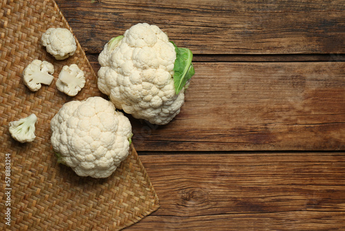 Fresh cauliflower on wooden table, top view. Space for text