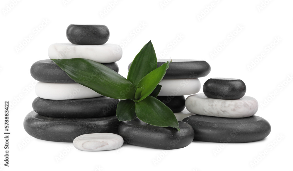 Stacks of spa stones and bamboo leaves on white background Stacks of spa stones and bamboo leaves on white background
