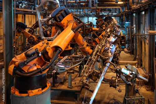 Contemporary robotic welding machines in plant workshop