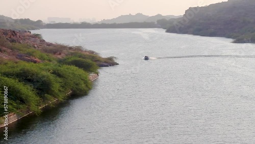 speedboat running fast at lake at day from top angle video is taken at kaylana lake jodhpur rajasthan india. photo