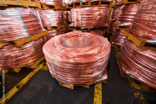 Stacks of copper wire rods in production plant warehouse photo