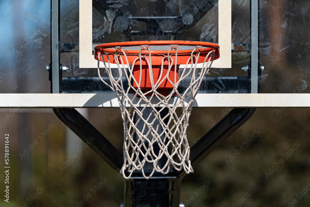 Close up of an isolated basketball goal net and backboard with a shallow depth of field