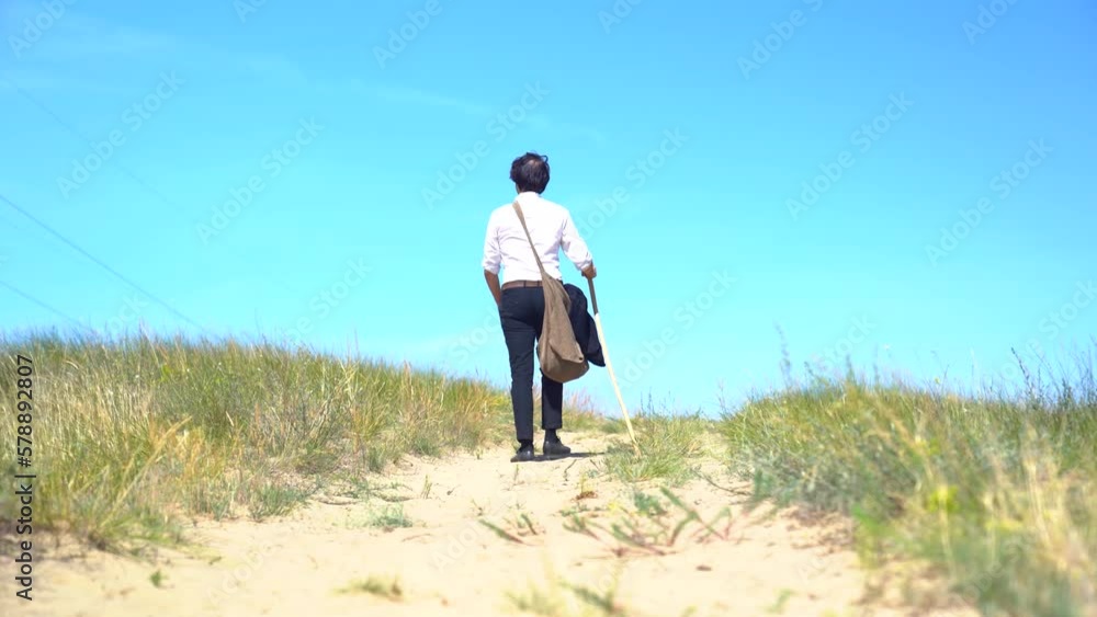 Actor portraying Hungarian poet Sandor Petofi walks up hill on dirt path. Actor portraying Hungarian poet Sandor Petofi walks up hill on dirt path.