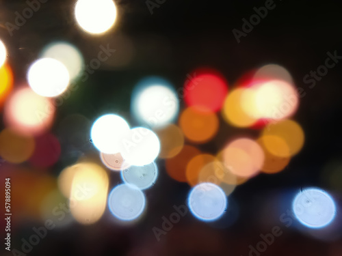 colorful bokeh lights background at night. blurry background and bokeh lights. and new year celebration bokeh particle lights concept 