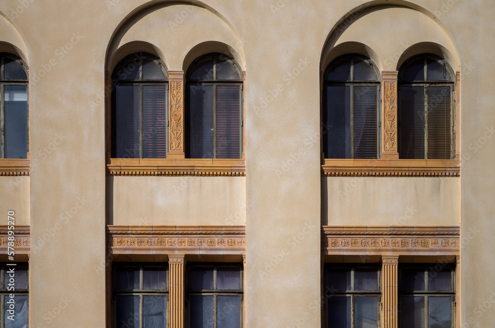 Yellow Facade and Arched Windows on a Beige Wall.