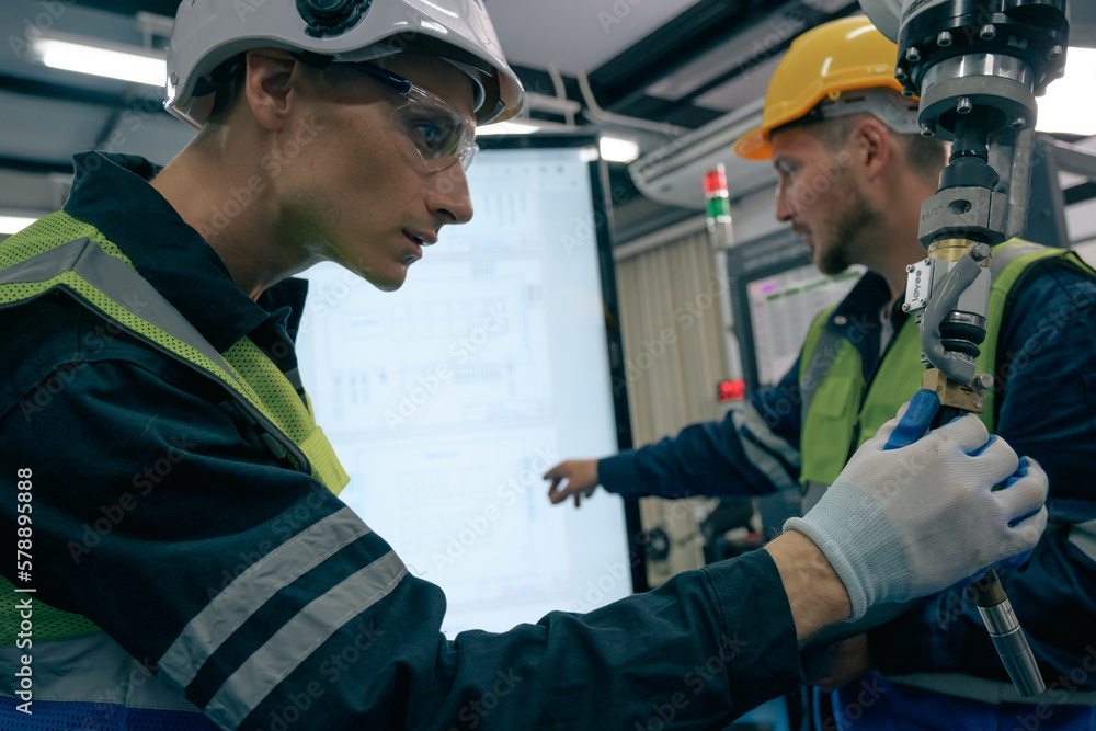 Multiracial tachnicial engineer training with robot arm Multiracial tachnicial engineer training with robot arm