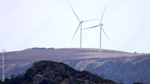 The wind turbines on Haramsfjellet, just north of Ålesund city, filmed from the mainland, Skjeltene, a day with lots of wind and good rotation on the turbines. photo