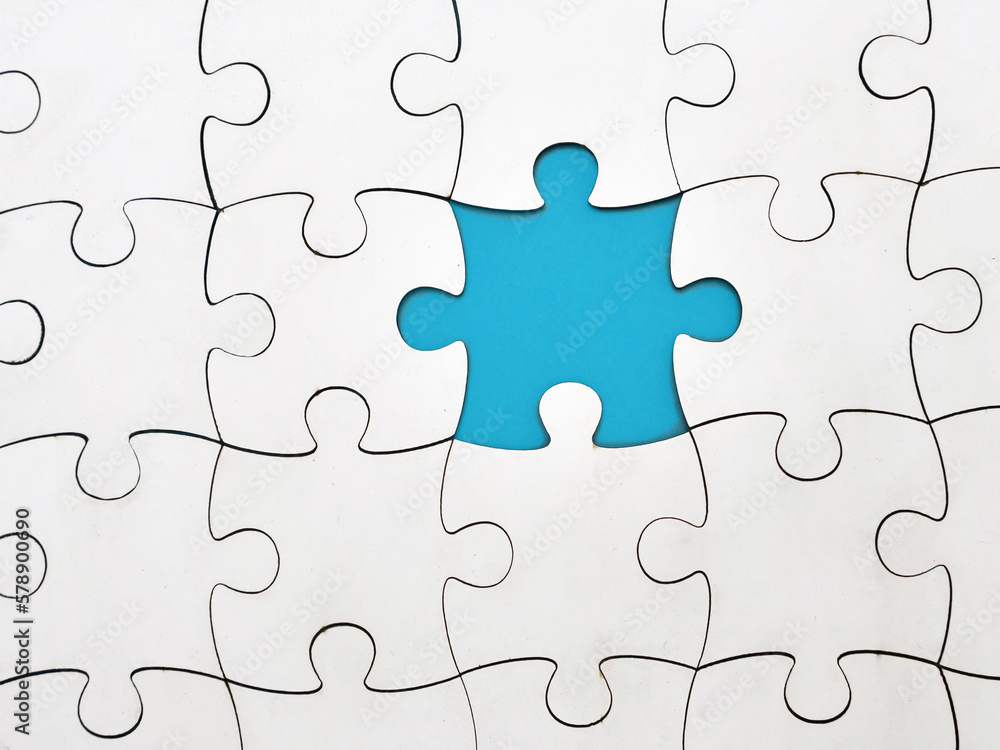 White jigsaw puzzle on blue background, top angle view White jigsaw puzzle on blue background, top angle view