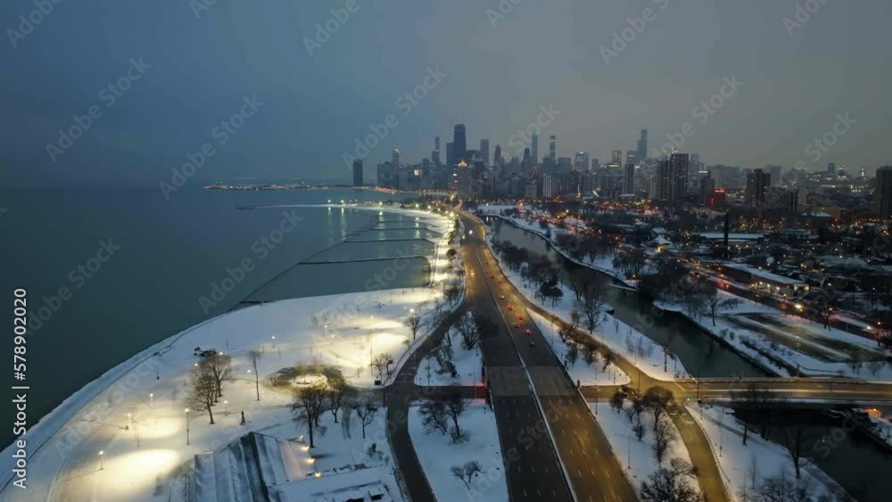 Drone shot over traffic on the Lake shore drive, snowy evening in Lincoln park, Chicago, USA Drone shot over traffic on the Lake shore drive, snowy evening in Lincoln park, Chicago, USA