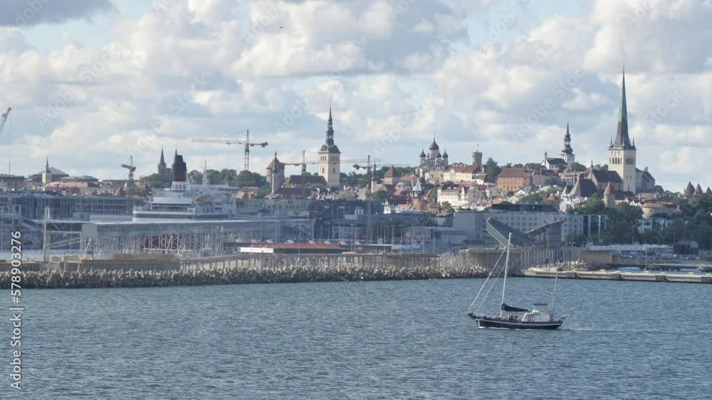 Tallinn.Estonia-August 28.2020: The floating small sailing boat in the ocean in Tallinn Estonia from the port of Tallinn on a summer day.geology shot.4k Tallinn.Estonia-August 28.2020: The floating small sailing boat in the ocean in Tallinn Estonia from the port of Tallinn on a summer day.geology shot.4k