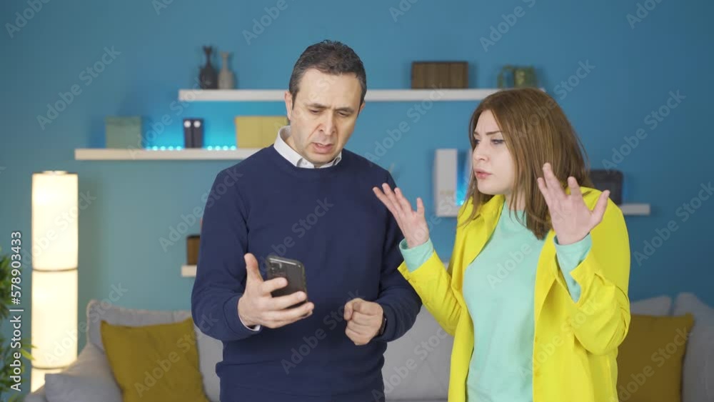 Father and daughter getting angry.
The father and daughter are angry at what they see on the phone.
Father and daughter getting angry.
The father and daughter are angry at what they see on the phone.