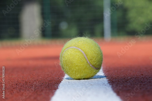 Tennis scene with white line and ball and racquets © NetPix