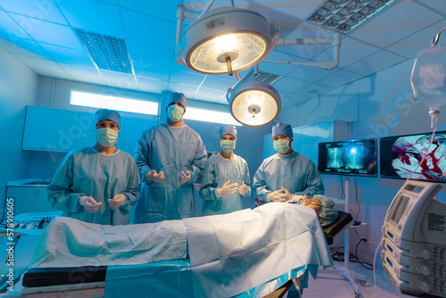 Medical Team Performing Surgical Operation in Modern Operating Room, Serious surgeons during a surgery in the hospital.