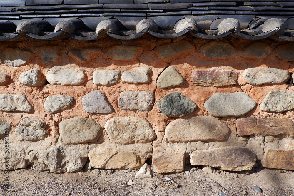 Old traditional stone wall and tile-roof. Korean traditional wall elements.