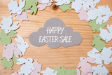 flat lay on wooden background with bunnies and discount text