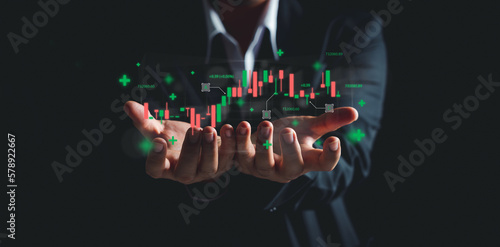 Businessman Trader online stock investing Showing growth of virtual hologram stock or tradeview graph.start up and stock market.Investor Plan to business growth goals of success, progress and profit. photo
