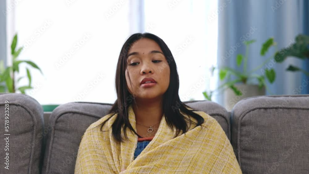 Illness, tissue and female blowing her nose while sitting on a sofa in the living room of her home. Covid, sick and Asian woman sneezing with flu, cold or allergies in the lounge of her modern house. Illness, tissue and female blowing her nose while sitting on a sofa in the living room of her home. Covid, sick and Asian woman sneezing with flu, cold or allergies in the lounge of her modern house.
