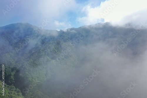 Panoramic view of a rainforest valley on Flores surrounded by a dense layer of haze clouds.