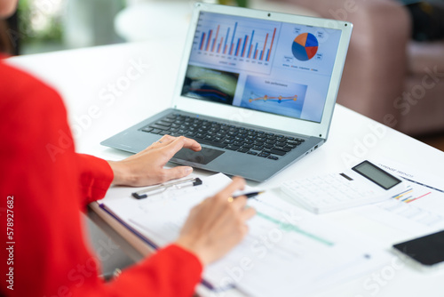 Woman working at home office hands on keyboard close-up