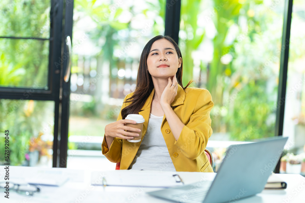 Tired of yawning, sleepy woman working at desk and holding coffee cup, overworked and sleep deprivation concept Tired of yawning, sleepy woman working at desk and holding coffee cup, overworked and sleep deprivation concept