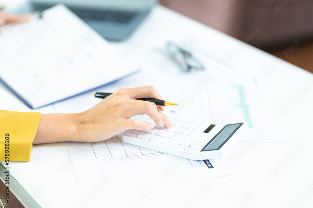 Portrait of asian business woman paying bills online with laptop in office. Beautiful girl with computer and checkbook, happy paying bills. Startup business financial calculate account concept Portrait of asian business woman paying bills online with laptop in office. Beautiful girl with computer and checkbook, happy paying bills. Startup business financial calculate account concept