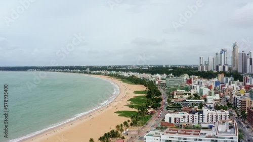 Right panning dolly out aerial drone shot of the cityscape of the colorful tropical beach capital city of Joao Pessoa in Paraiba, Brazil from the Tambaú neighborhood on an overcast morning. photo